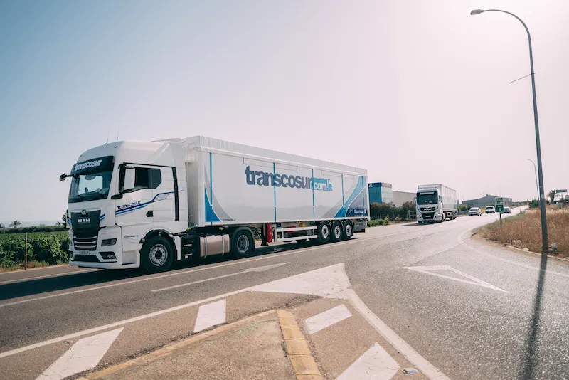 Transcosur lorry with a walking floor trailer driving along a road