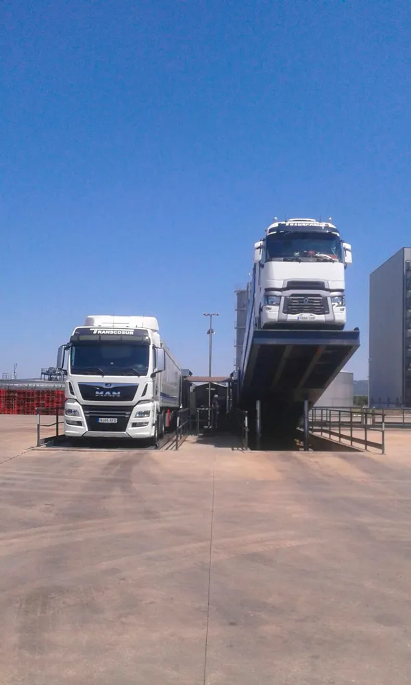 Transcosur lorry driving up a loading ramp, seen from the front